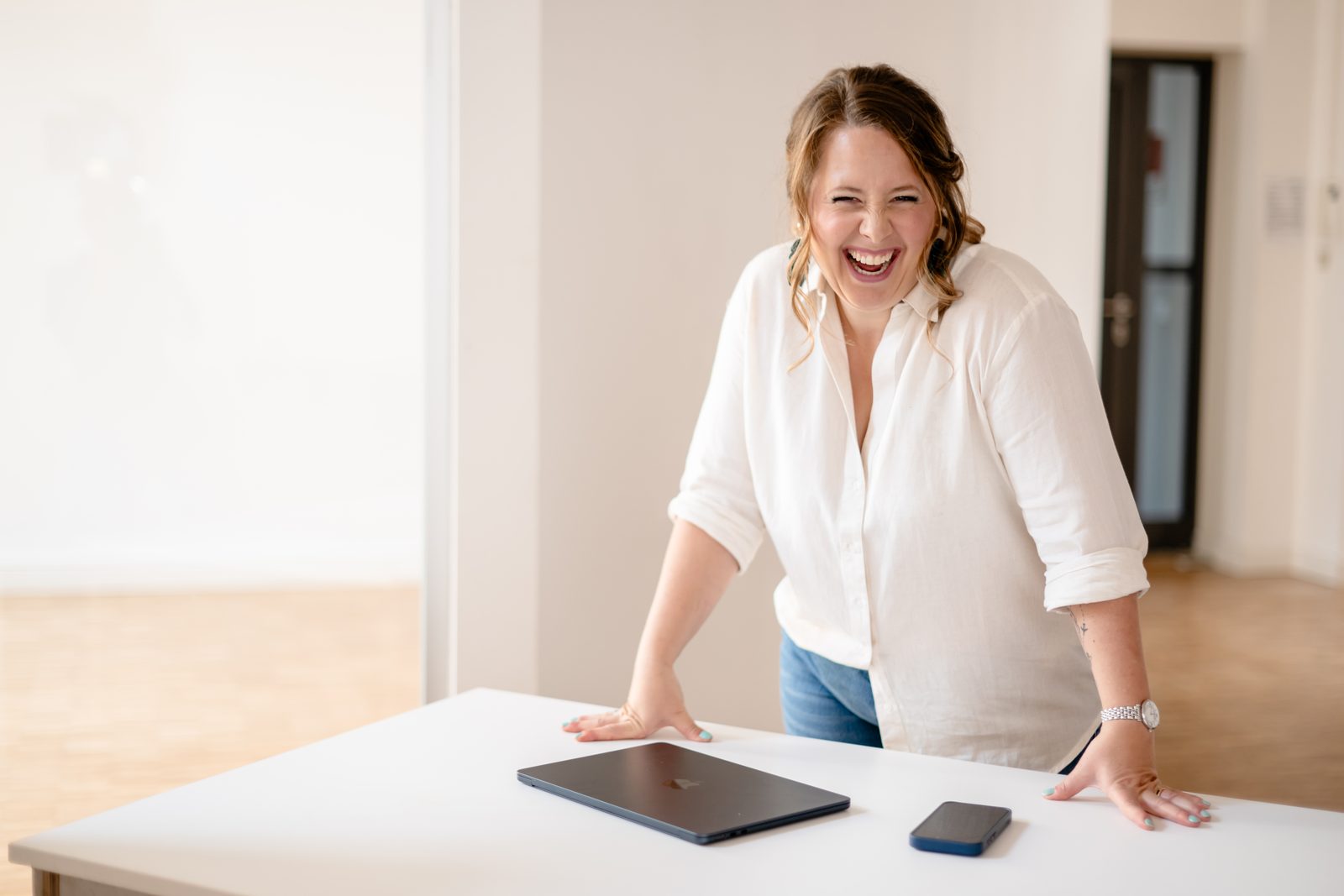 Isabel Ernst laughing at her desk